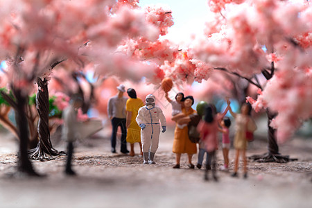 粉色儿童海报樱花树下的医护人员和游客背景