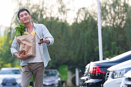 汽车超市幸福中年男人拿着购物袋背景