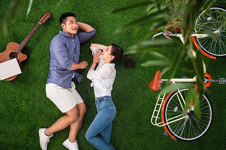 东亚丈夫情侣幸福的青年伴侣躺在草地上享受休闲时光图片