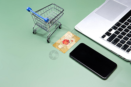 手机支付笔记本电脑和购物车模型手机银行卡背景