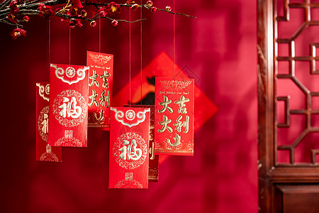 汉字福字元素悬挂在梅花下面的红包图片