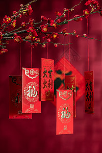红梅花摄影文字摄影汉字悬挂在梅花下面的红包背景