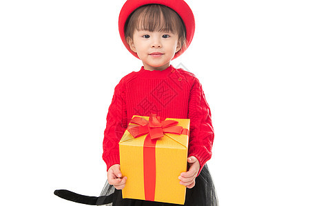 人节日好奇心可爱的小女孩拿着新年礼物图片