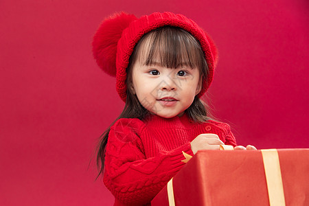 亚洲无忧无虑春节可爱的小女孩拿新年礼物上图片