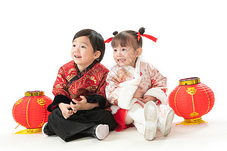 彩色图片愉悦摄影庆祝新年的两个小朋友坐在地上玩耍图片