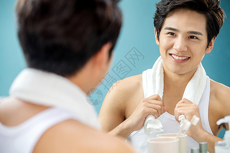 人享乐欣赏快乐的年轻男人拿着毛巾照镜子图片