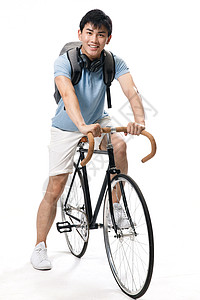 骑自行车学生背景分离青年青年文化年轻的大学生骑自行车背景