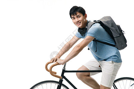 户内面部表情时尚年轻的大学生骑自行车图片