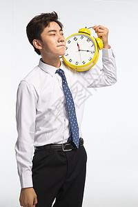 亚洲时间仅男人商务青年男人拿着闹钟图片