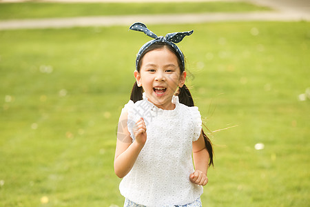 小女孩奔跑发饰裙子健康生活方式小女孩在户外玩耍背景