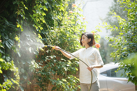 青年女人户外浇花高清图片