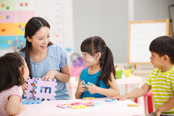 教育老师和儿童在娱乐室玩耍图片