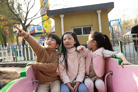 小孩嬉戏伙伴户外活动公园男孩女孩坐过山车背景