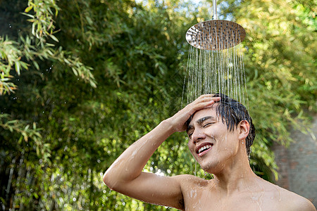 脸颊青年男人湿年轻男人在户外淋浴洗头图片