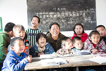 乐观指导教师贫穷乡村女教师和小学生在教室里图片
