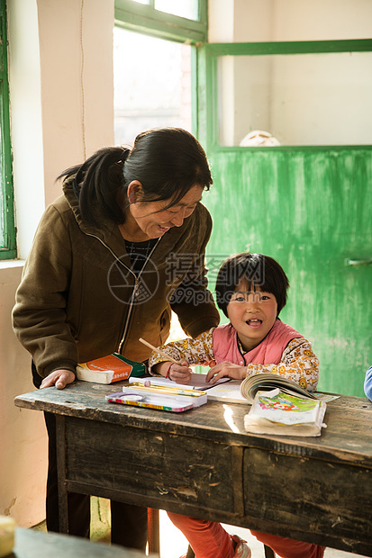 坐着智慧乡村女教师和小学生在教室里图片