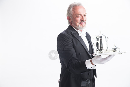手套摄影60到64岁一个男侍者托着银餐具图片