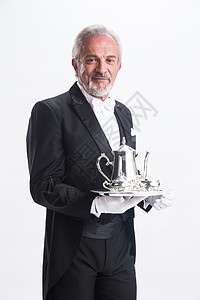 酒店水壶水壶活力仅一个老年男人一个男侍者托着银餐具背景