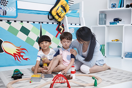 中国儿童放松享乐装饰物可爱的小男孩和指导教师在游戏室玩耍背景