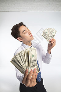 现代储蓄商务青年男人拿着美元图片