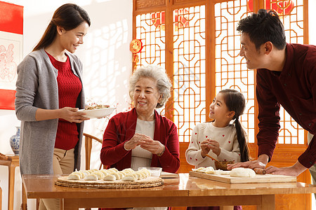 饮食亚洲夫妇幸福家庭过年包饺子图片