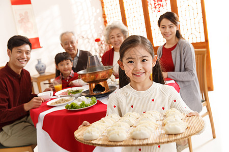 冬至祝福少量人群两个孩子的家庭快乐小女孩过年端着饺子背景