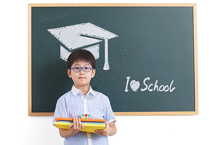 男孩努力学习学龄儿童努力表现积极小学男生站在黑板前背景