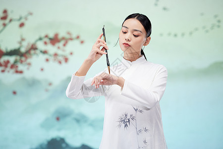 中国风美女手拿毛笔写书法背景图片