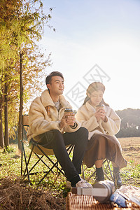 年轻情侣坐在户外椅子上休闲放松图片