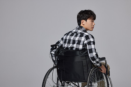 坐轮椅的年轻男性背影图片