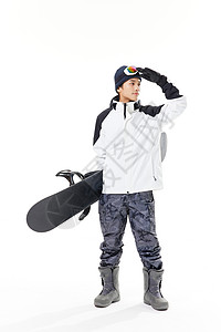年轻男性拿着滑雪板手扶滑雪镜图片