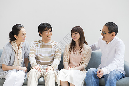 一家人坐在沙发上开心的聊天图片