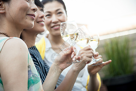 花园聚会上手拿葡萄酒的妇女图片