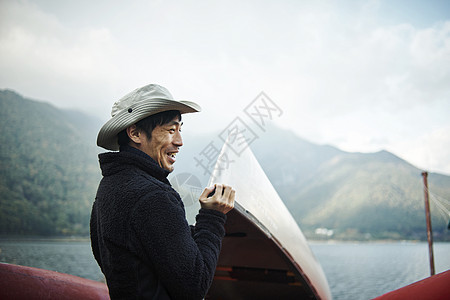 海边手拿皮划艇的男性图片