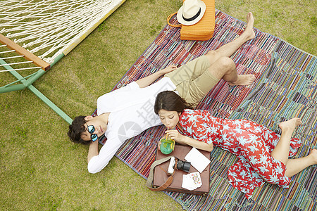 年轻情侣度假约会在野餐垫上休息休闲高清图片素材