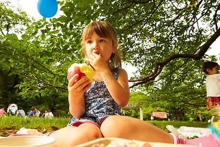 公园里小女孩享受野餐图片