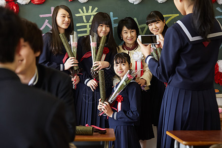 穿水手服女生拍照留念的学生们背景