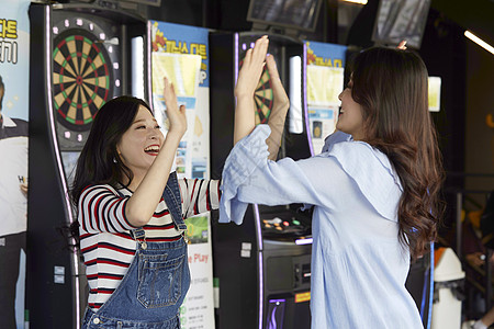 年轻女孩玩飞镖游戏背景