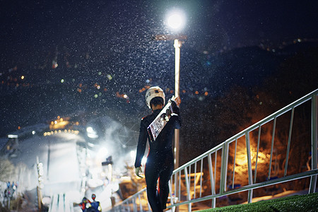 夜晚训练跳台滑雪的运动员背影背景图片