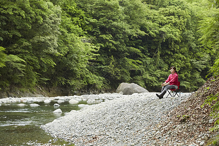 女人坐在河边享受自然图片