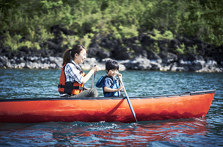 享受自我小学生假期划独木舟的家庭图片
