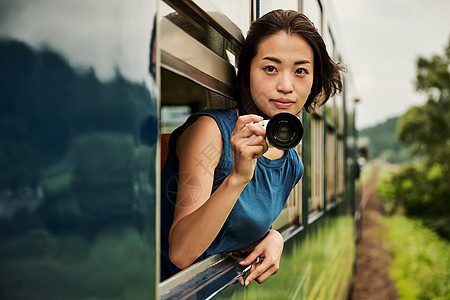 围栏肖像秋田从车窗采取的女背包徒步旅行者图片