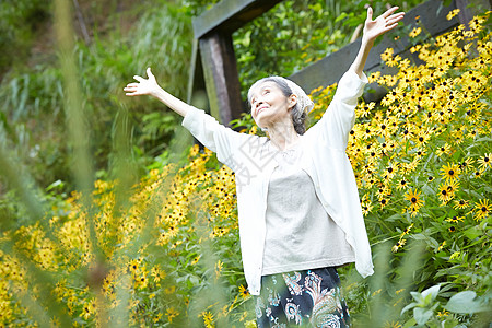 站在花田里开心的老奶奶图片