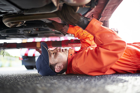 在车底检修故障的道路救援服务人员高清图片