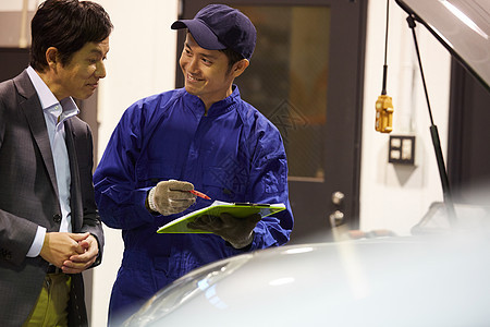 日本人人类室内汽车维修引擎技工和客户图片