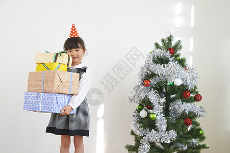 圣诞节派对有圣诞树和礼物的女孩背景