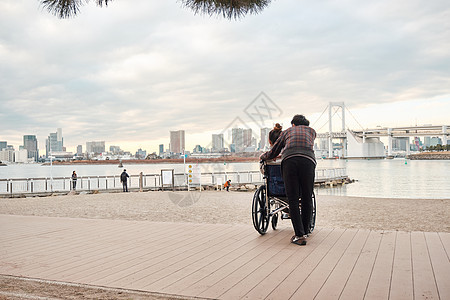 海岸亚洲人20多岁轮椅妇女和男子图片