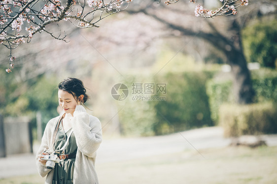 度假肖像照相机樱花拍照片的春天妇女图片