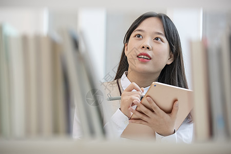 高中女学生在书架上查找书籍图片