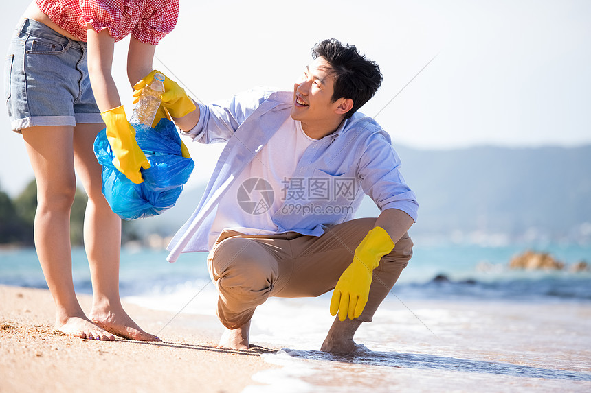 打工全体环境问题男人和女人做海滩清洁图片